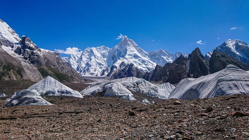 Scenic view of snowcapped mountains against blue sky