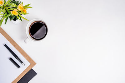 Directly above shot of coffee on table against white background