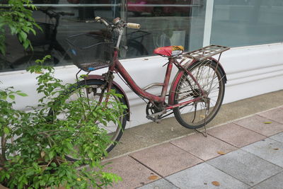 Bicycle parked against building
