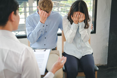 Therapist advising couple in clinic