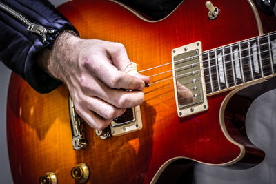 Close-up of man playing guitar