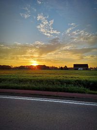 Scenic view of field against sky during sunset