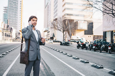 Young man standing on street in city