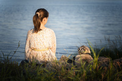 Side view of young woman looking away in forest