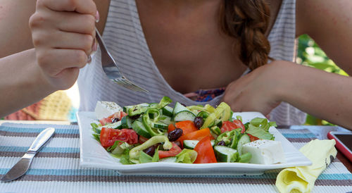 Midsection of man eating food