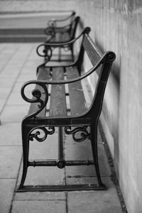 High angle view of empty bench on table against wall