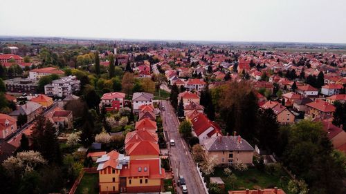 Aerial view of houses in town against clear sky