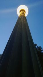 Low angle view of illuminated tower against sky at night