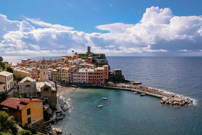 High angle view of buildings by sea against sky