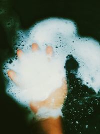 Close-up of hand holding bubbles