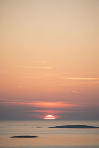 Scenic view of sea against orange sky