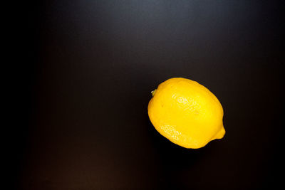 Close-up of apple against orange background