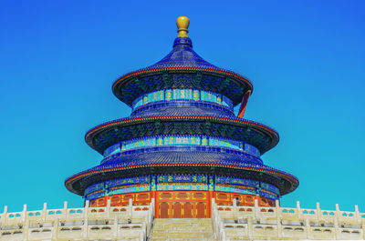 Low angle view of temple building against blue sky