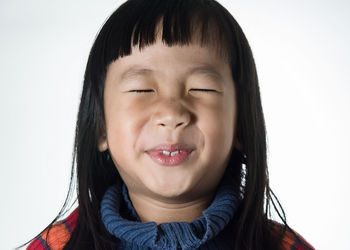 Close-up portrait of a boy against white background