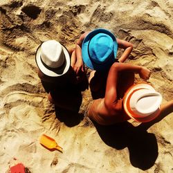 High angle view of man wearing hat on sand