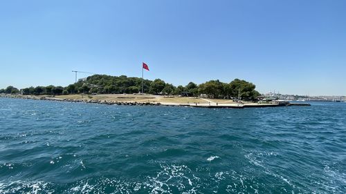 Scenic view of sea against clear blue sky