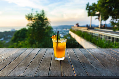 Close-up of drink on table during sunset