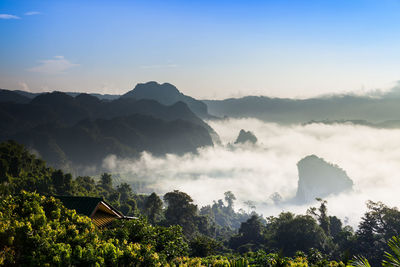 Scenic view of mountains and trees against sky