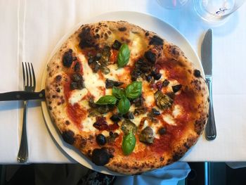 High angle view of pizza served on table