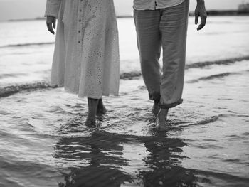 Low section of people standing in puddle