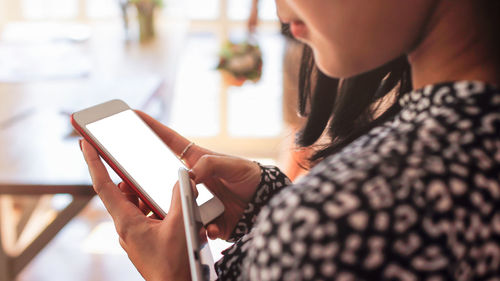 Midsection of woman using mobile phone