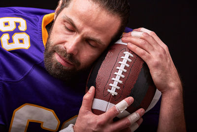 Portrait of man holding camera at home