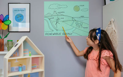 High angle view of girl drawing on table