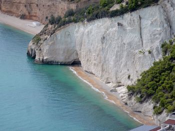 High angle view of rocks on sea shore