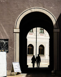 Rear view of silhouette people walking in building