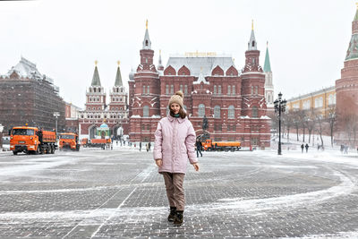 Full length rear view of man standing in city during winter