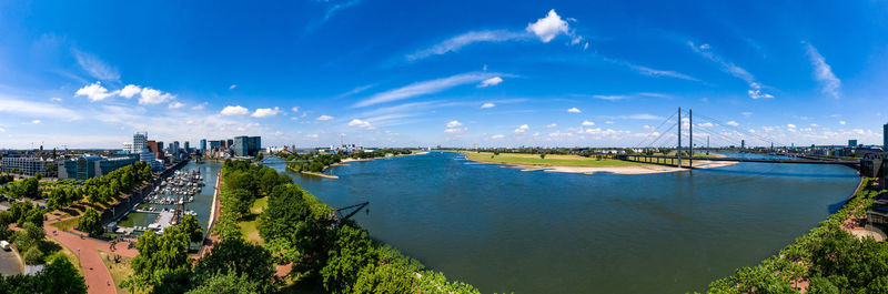 High angle view of bay against blue sky