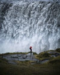 Rear view of man standing on shore