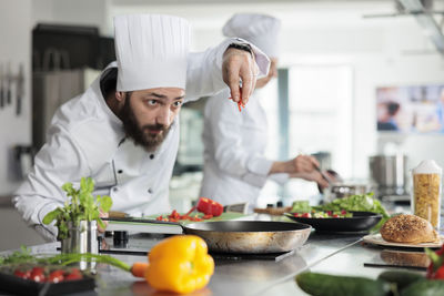 Portrait of woman preparing food at home