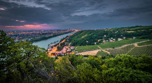 Scenic view of agricultural field against sky during sunset