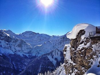 Scenic view of snow covered mountains against clear sky