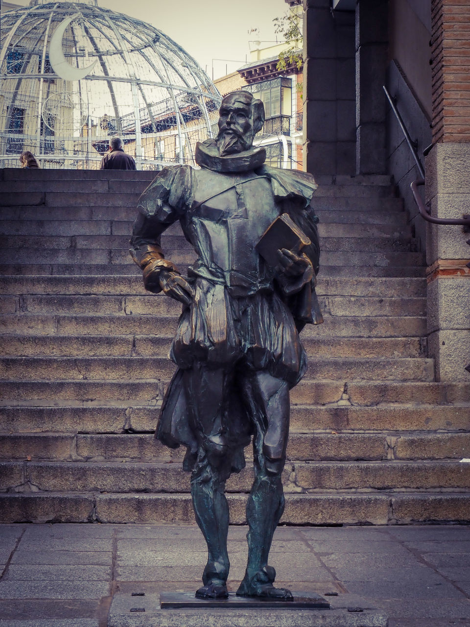 architecture, city, built structure, full length, building exterior, clothing, person, statue, government, monument, one person, weapon, adult, street, protection, security, outdoors, art, military, day