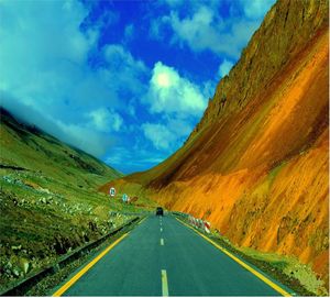 Scenic view of road amidst mountains against sky