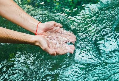 Low section of man swimming in water