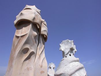 Low angle view of statue against blue sky