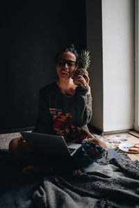 Woman holding pinepapple at home