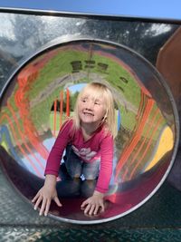 Happy girl playing in playground