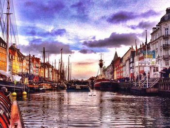 Boats in harbor with buildings in background