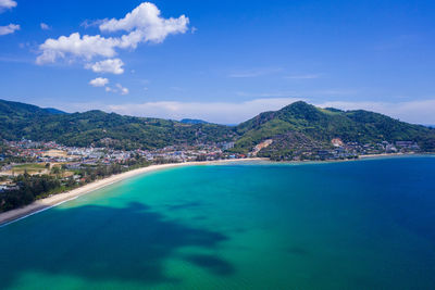 Scenic view of sea and mountains against sky