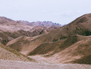 Scenic view of arid landscape against sky