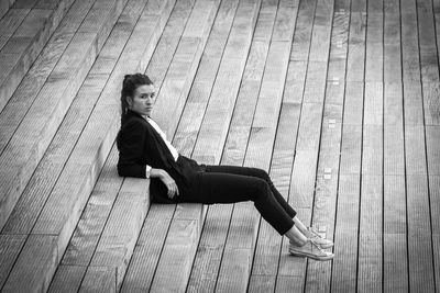 Full length of woman relaxing on stairs