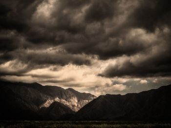 Scenic view of mountains against cloudy sky