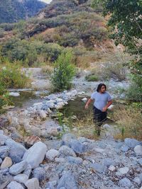 Full length of woman walking in stream