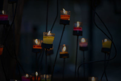 Close-up of electric lights hanging on wall