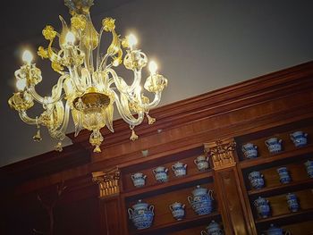 Low angle view of illuminated chandelier in building