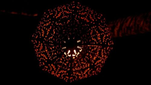 Close-up of illuminated lighting equipment in darkroom